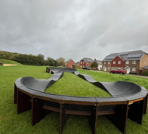 Modular pump track installed in the parish, with children enjoying the facility